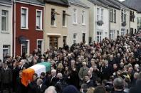 The coffin of Martin McGuinness is carried through crowded streets during his funeral in Londonderry, Northern Ireland, March 23, 2017. REUTERS/Phil Noble