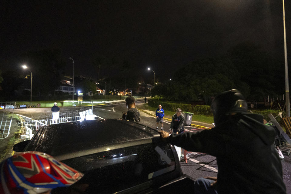 Residents stand in a blockade in Noumea, New Caledonia, Wednesday May, 15, 2024. Violence is raging across New Caledonia for the third consecutive day and France has imposed a state of emergency in the French Pacific territory. (AP Photo/Nicolas Job)