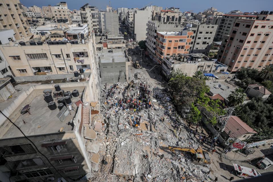 Palestinian civil defence search for survivors in the rubble of a destroyed house after an Israeli air strike in Gaza CityEPA