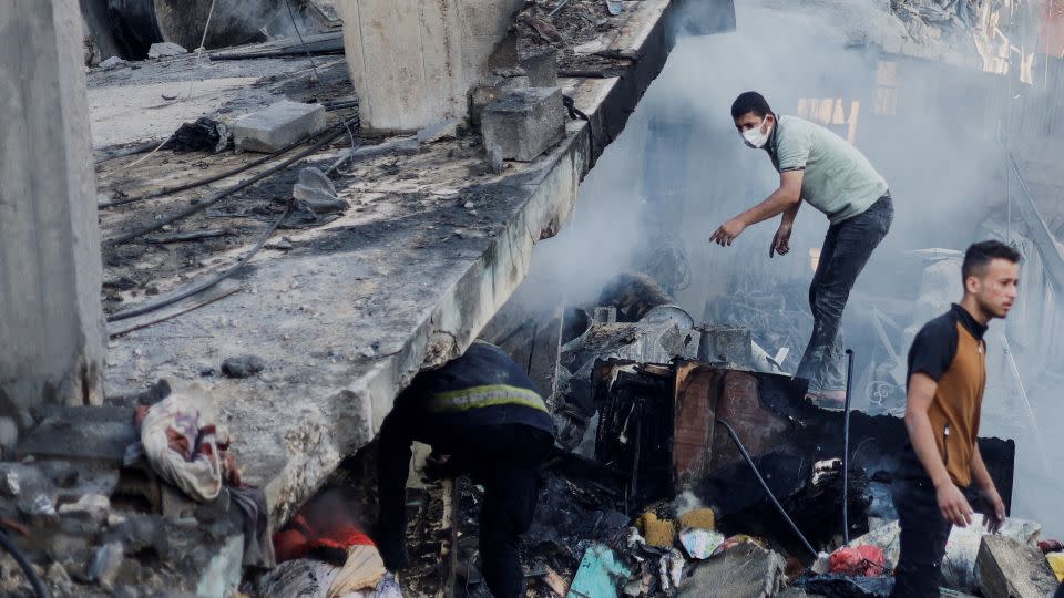 Palestinians search for casualties under the rubble in the aftermath of Israeli strikes, amid the ongoing conflict between Israel and the Palestinian Islamist group Hamas, in Khan Younis in the southern Gaza Strip, October 14. - Mohammed Salem/Reuters