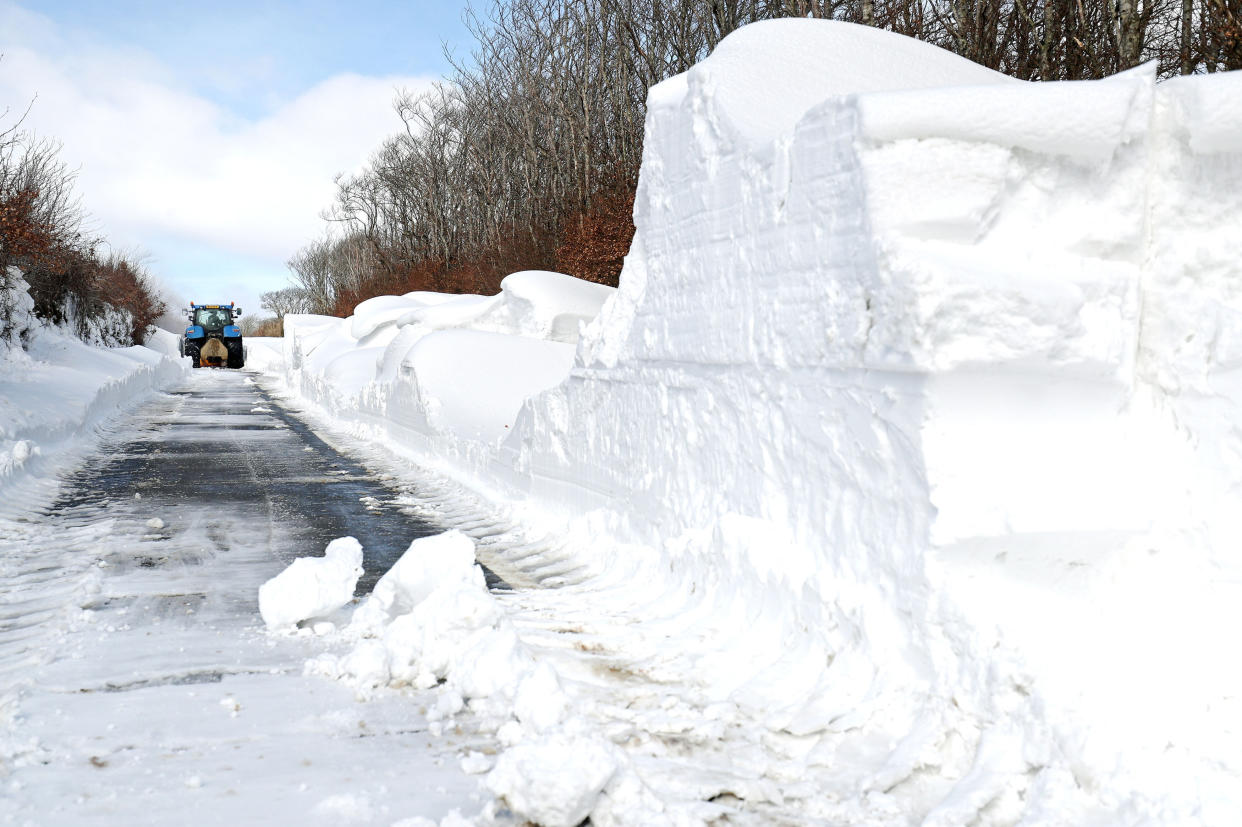 A farmer in a tractor helps to clear the snow from a blocked road heading out of Simonsbath in Exmoor National park, as the icy conditions brought by the &quot;Mini Beast from the East&quot; are set to cling on for one more day before Britain will see the return of spring.