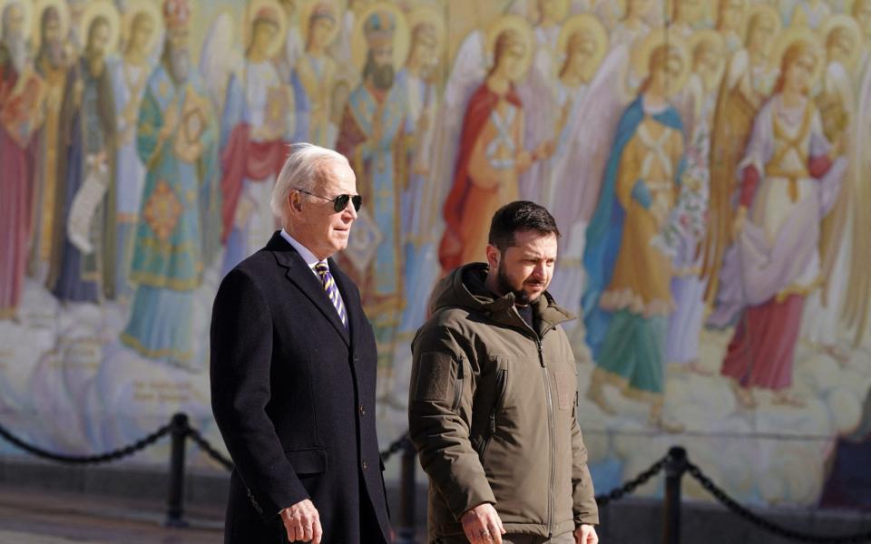 US President Joe Biden (L) walks next to Ukrainian President Volodymyr Zelensky (R) as he arrives for a visit in Kyiv on February 20, 2023 - DIMITAR DILKOFF/AFP