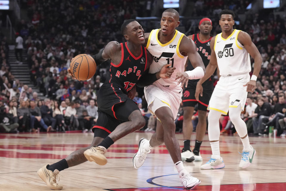 Toronto Raptors guard Dennis Schroder (17) drives against Utah Jazz guard Kris Dunn (11) during second-half NBA basketball game action in Toronto, Saturday, Dec. 23, 2023. (Chris Young/The Canadian Press via AP)