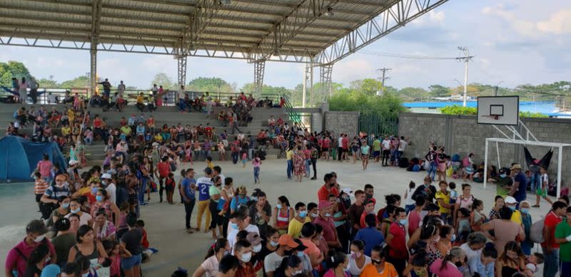 Venezuelan migrants are seen inside a coliseum where a temporary camp is installed, after fleeing their country due to military operations, according to the Colombian migration agency, in Arauquita