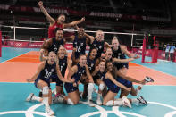 United States players celebrate winning the women's volleyball semifinal match between Serbia and United States at the 2020 Summer Olympics, Friday, Aug. 6, 2021, in Tokyo, Japan. (AP Photo/Frank Augstein)