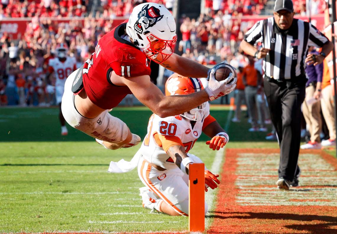 N.C. State linebacker Payton Wilson (11) dives in to score on a 15-yard touchdown interception during the second half of N.C. State’s 24-17 victory over Clemson at Carter-Finley Stadium in Raleigh, N.C., Saturday, Oct. 28, 2023.