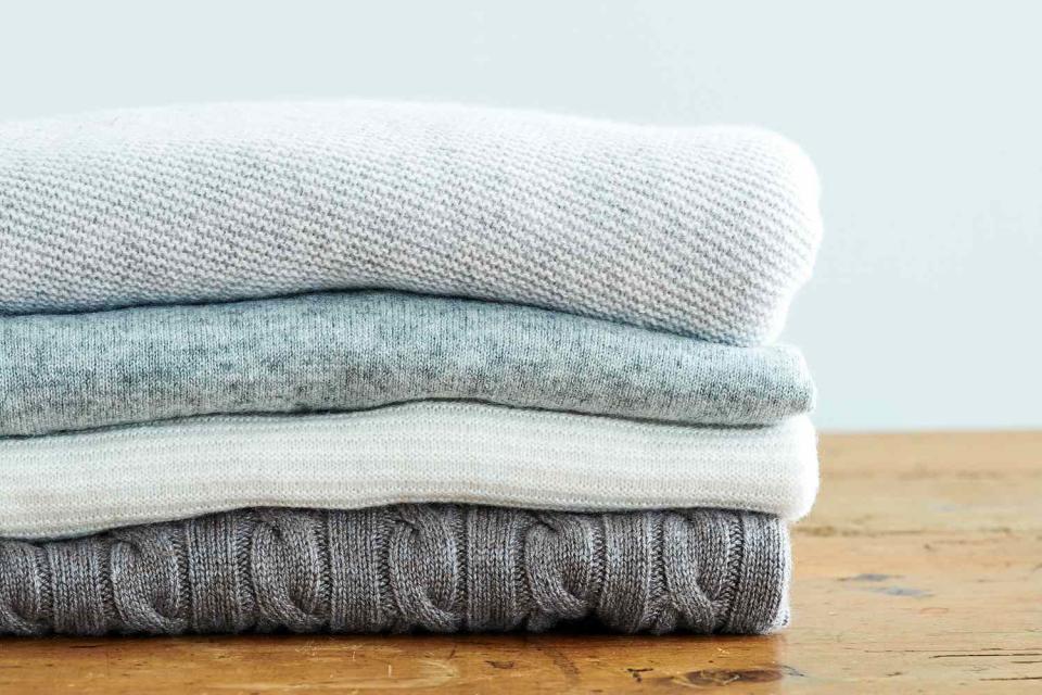 cashmere sweaters on wood table