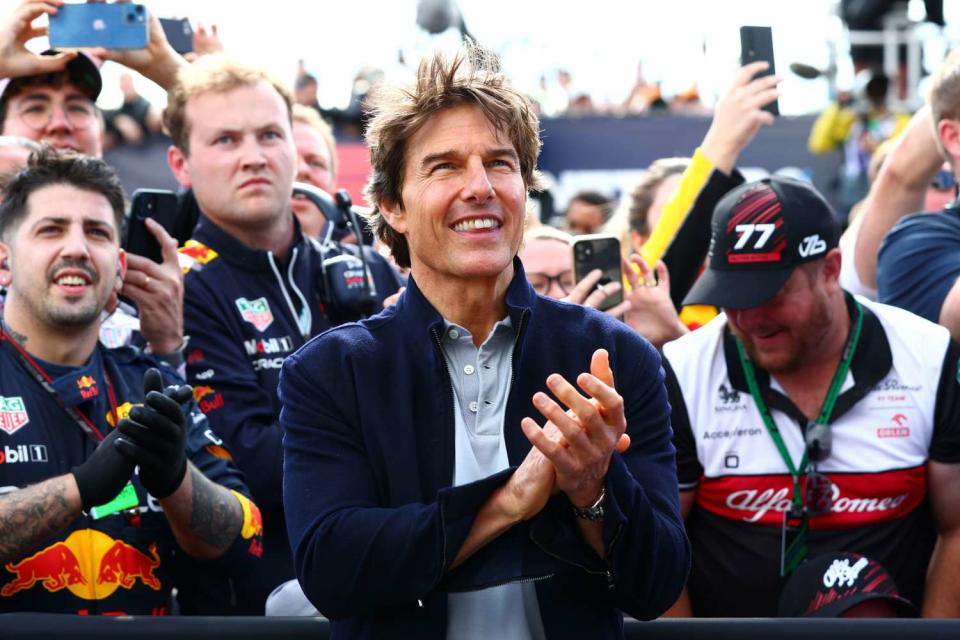 NORTHAMPTON, ENGLAND - JULY 03: Tom Cruise applauds at the Podium celebrations during the F1 Grand Prix of Great Britain at Silverstone on July 03, 2022 in Northampton, England. (Photo by Mark Thompson/Getty Images)