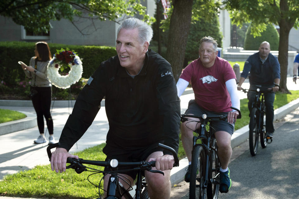 FILE - House Speaker Kevin McCarthy, of Calif., leads fellow members of Congress and law enforcement officers as they arrive at the National Law Enforcement Officers Memorial, in Washington, Thursday, May 11, 2023. McCarthy lead his "Back the Blue" bike tour of Washington, before laying wreaths at the memorial. (AP Photo/Cliff Owen, File)