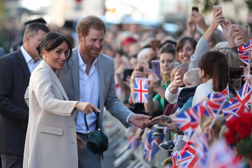 Prince Harry, Duke of Sussex and Meghan, Duchess of Sussex greet wellwishers on arrival in Chichester (AFP/Getty Images)