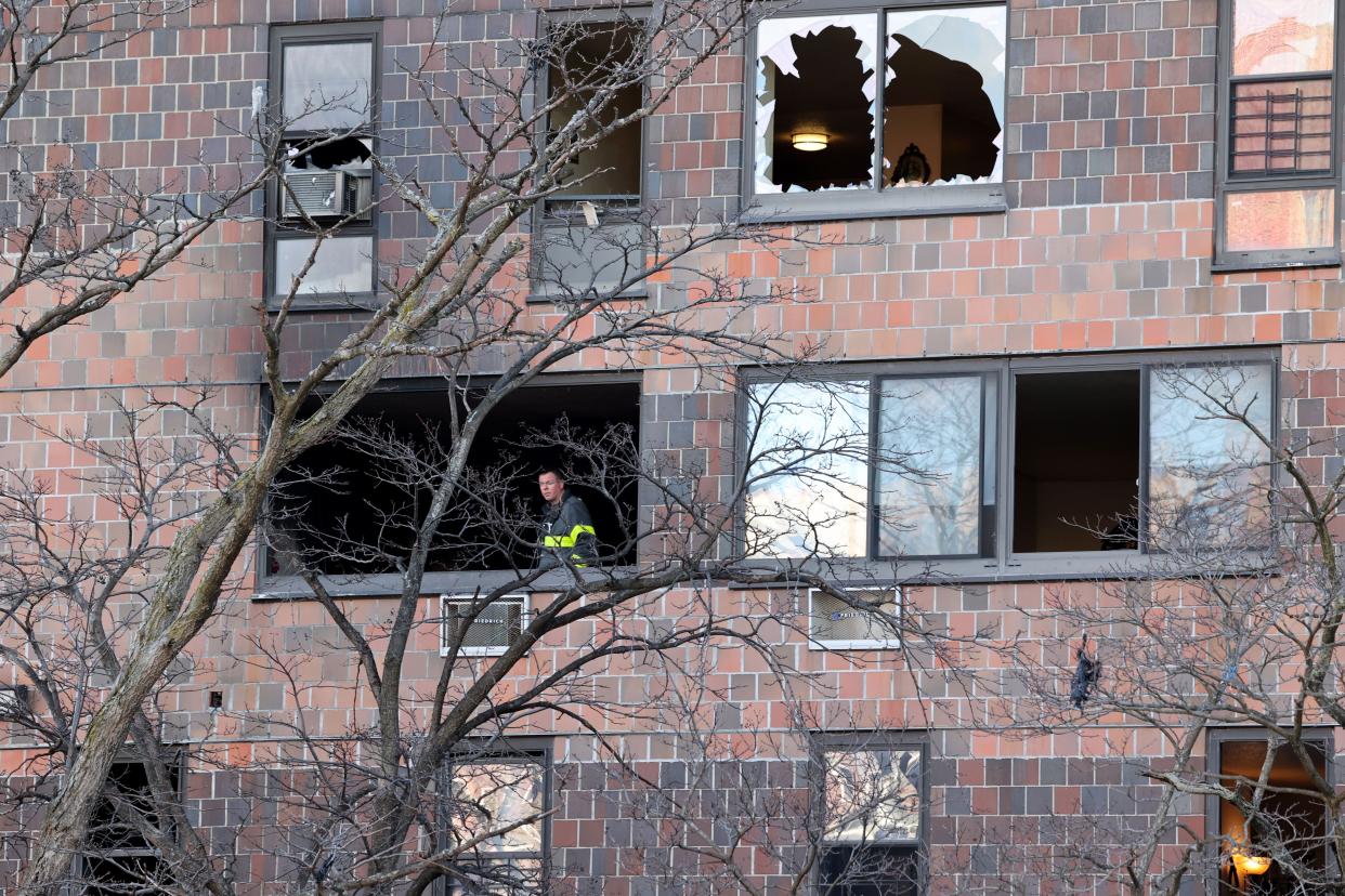An FDNY firefighter looks out from a burned apartment at the Twin Parks North West building on Jan. 10.