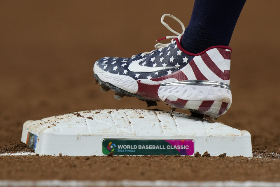 U.S. designated hitter Kyle Schwarber (12) walks to first base during third inning of a World Baseball Classic championship game against Japan, Tuesday, March 21, 2023, in Miami. (AP Photo/Wilfredo Lee)