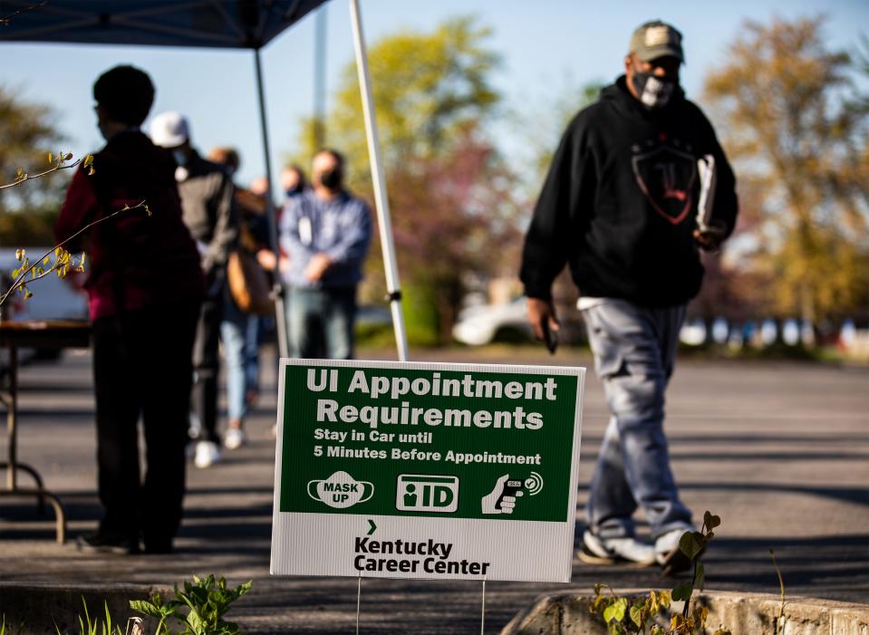 A man walks with his paperwork after checking in at the Kentucky Career Center on April 15, 2021.