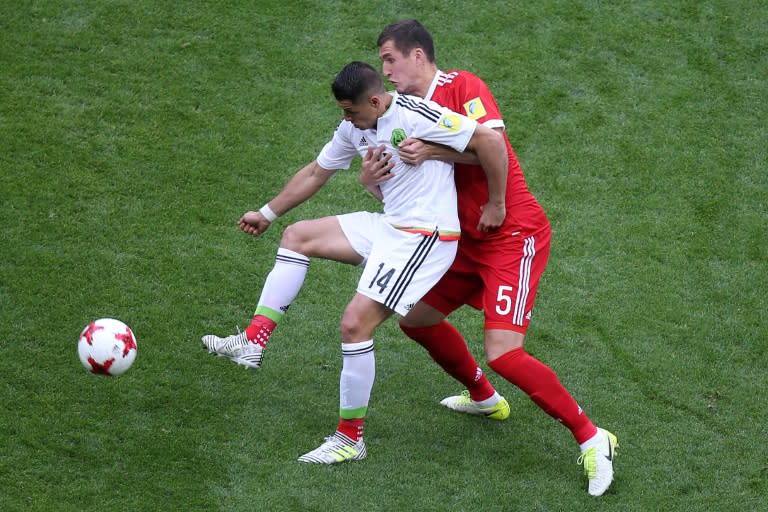 Mexico forward Javier Hernandez (L) vies for the ball with Russia defender Viktor Vasin during the 2017 Confederations Cup group A match in Kazan on June 24, 2017