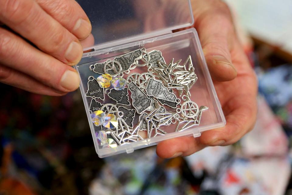 Michael Stone ties the end of his origami with charms at the  Brixham Montessori Friends School in York.