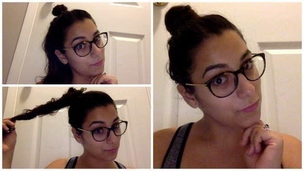 A girl with dark hair and glasses wearing her hair in a bun