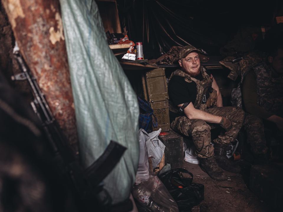 Ukrainian soldiers take shelter from Russian shelling in a trench in the direction of Bakhmut on March 22, 2023.