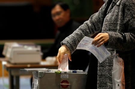 A woman casts her ballot for a national election at a polling station in Tokyo, Japan, October 22, 2017. REUTERS/Toru Hanai