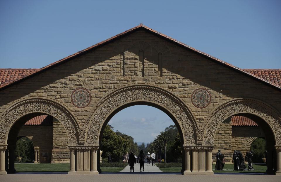 Pedestrians walk on the campus at Stanford University in Stanford, Calif., April 9, 2019.