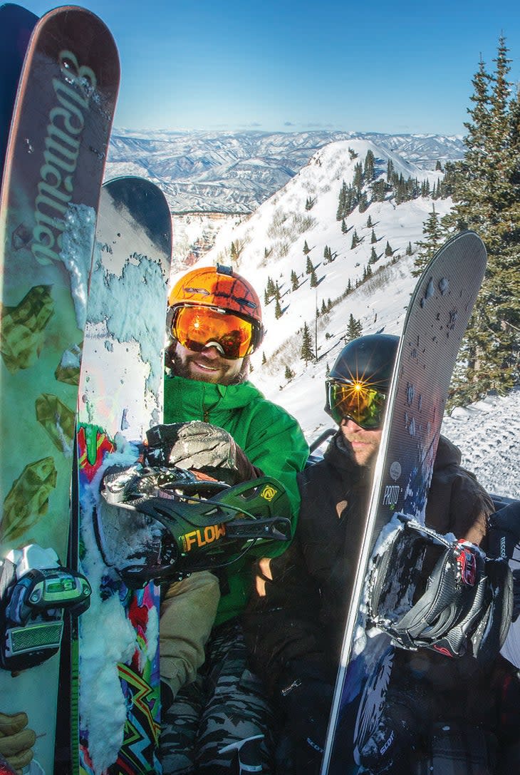 "Snowboarders riding the cat up Aspen Highlands Bowl"