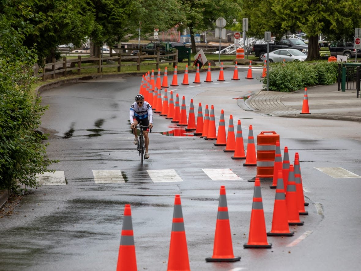 Cyclists and cars share the road through Stanley Park in Vancouver, British Columbia, on Tuesday, June 23, 2020. The short-term future of the dedicated bike lane in the park is on the table at a city park board meeting Monday. (Ben Nelms/CBC - image credit)