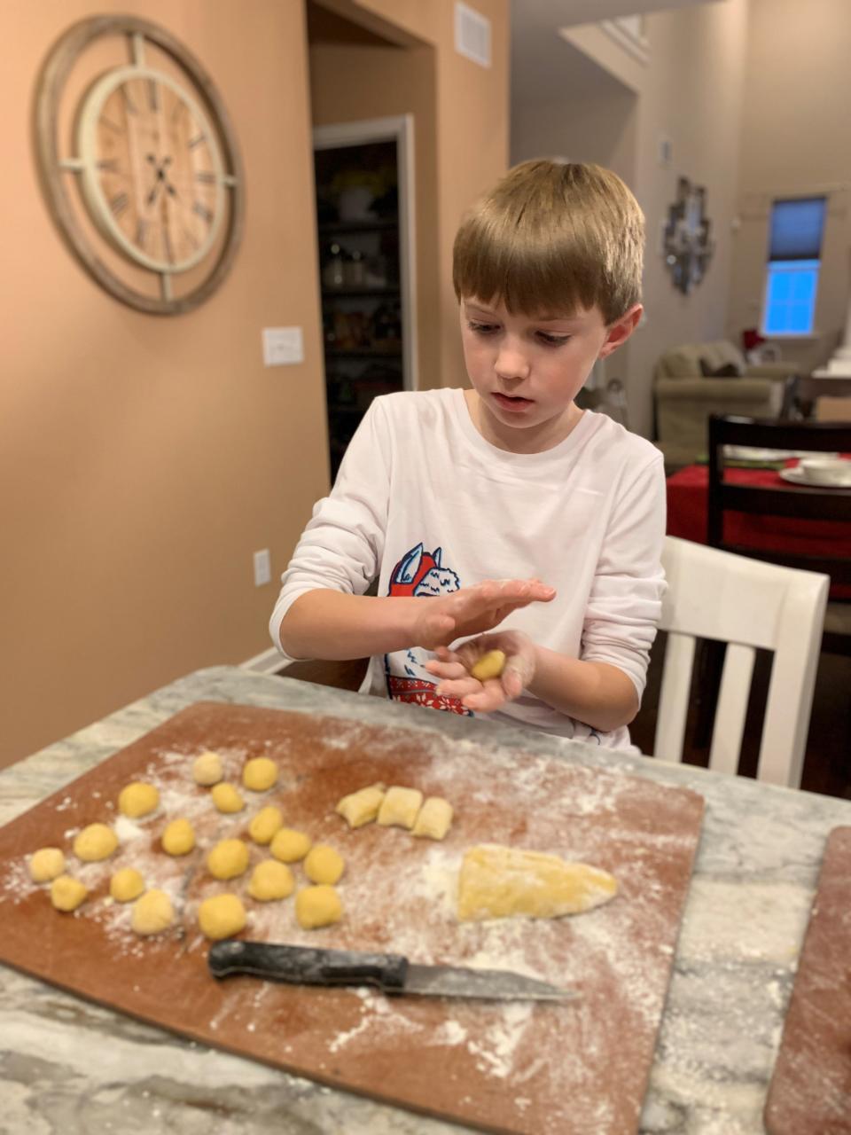 Aiden Griesemer, son of Asbury Park Press food writer Sarah Griesemer, rolls struffoli dough in their Barnegat home.