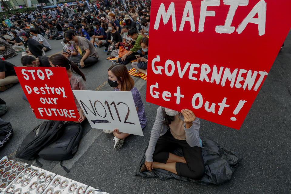 Pro-democracy activists display placards during a rally in Bangkok, Thailand, Wednesday, March 24, 2021, ahead of indictment against 13 protest leaders on Thursday for allegations of sedition and defaming the monarchy. (AP Photo/Sakchai Lalit)