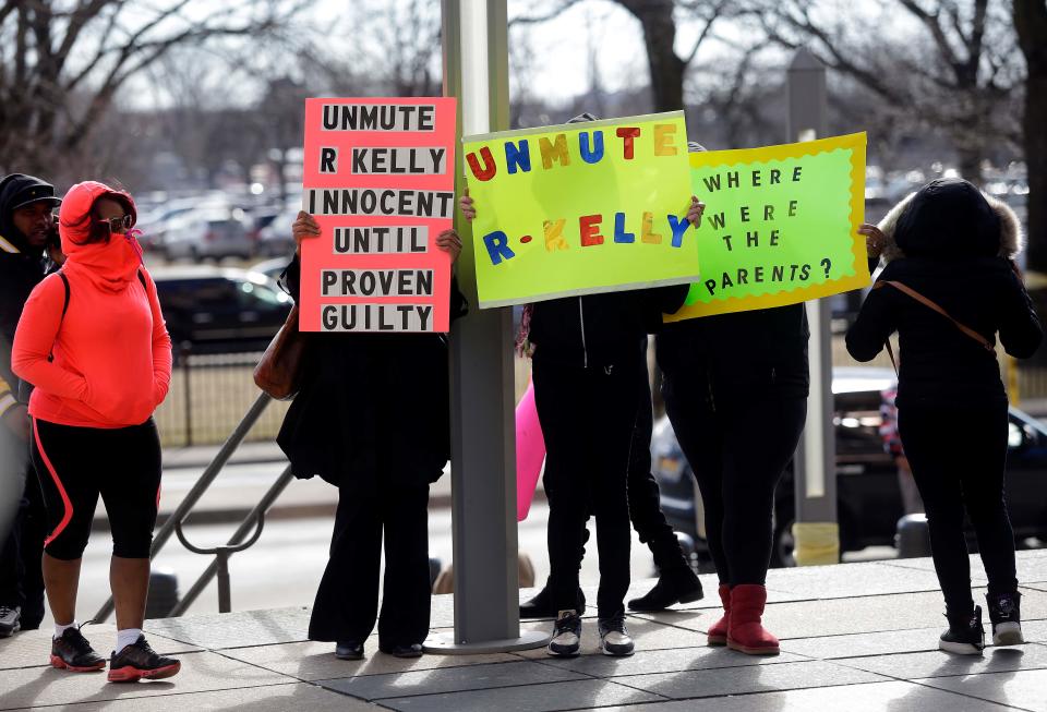 R. Kelly fans display signs supporting the singer outside the courthouse.