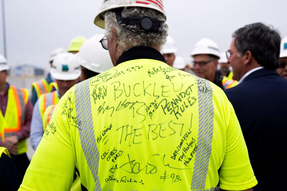 Robert Buckley, president of construction firm Buckley & Co., has his shirt signed during a news conference to announce the reopening of Interstate 95 Friday, June 23, 2023 in Philadelphia. Workers put the finishing touches on an interim six-lane roadway that will serve motorists during construction of a permanent bridge.