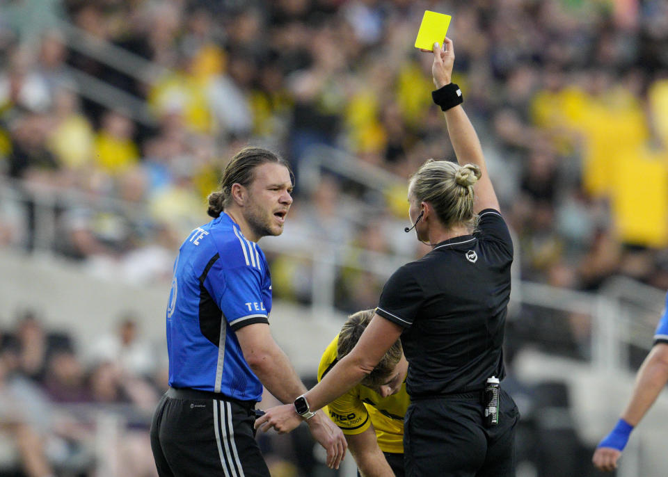 CF Montréal midfielder Samuel Piette, center left, is issued a yellow card during the first half of the team's MLS soccer match against the Columbus Crew on Saturday, April 27, 2024, in Columbus, Ohio. (AP Photo/Jeff Dean)