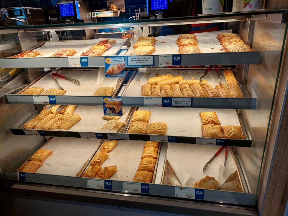 Shelves of baked goods, including sausage rolls, at Greggs