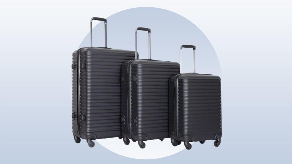 The black suitcases in different sizes on a blue background. 
