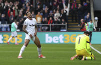 West Ham United's Emerson Palmieri, reacts after scoring an own goal to give Crystal Palace their third goal of the game during the English Premier League soccer match between West Ham United and Crystal Palace at Selhurst Park, London, Sunday April 21, 2024. (Steven Paston/PA via AP)