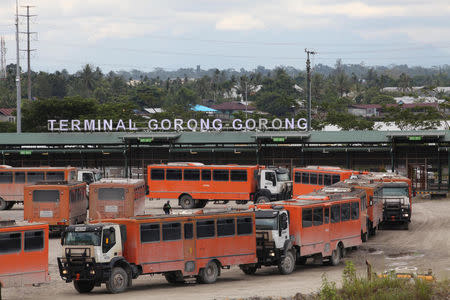 Vehicles used for transporting workers to the Grasberg copper mine operated by Freeport McMoRan Inc are seen at the Gorong-Gorong terminal in Timika, Mimika, Papua province, Indonesia on November 16, 2017. REUTERS/Muhammad Yamin