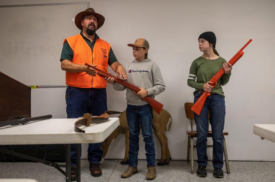 Nick Parks, left, Frank Romine, middle, and Rachel Slone lead a gun safety lesson at the Washtenaw Sportsman's Club during the Hunter Safety Field Day in Ypsilanti on Saturday, Sept. 9, 2023.