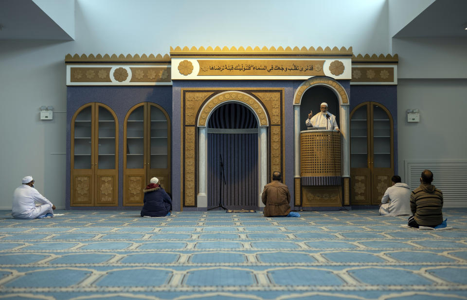 Muslims who live in Greece pray inside the first state-funded mosque in Athens on Friday, Nov. 6, 2020. Friday prayers have been held for the first time in the Greek capital's first state-sponsored mosque, which opened this week after years-long delays. The project to build a mosque in Athens has taken about 14 years and was dogged by protests, political controversy and delays in this heavily Christian Orthodox country. (AP Photo/Petros Giannakouris)