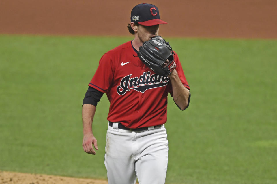 Cleveland Indians starting pitcher Shane Bieber (57) walks to the dugout in the fourth inning of Game 1 of an American League wild-card baseball series against the New York Yankees, Tuesday, Sept. 29, 2020, in Cleveland. (AP Photo/David Dermer)