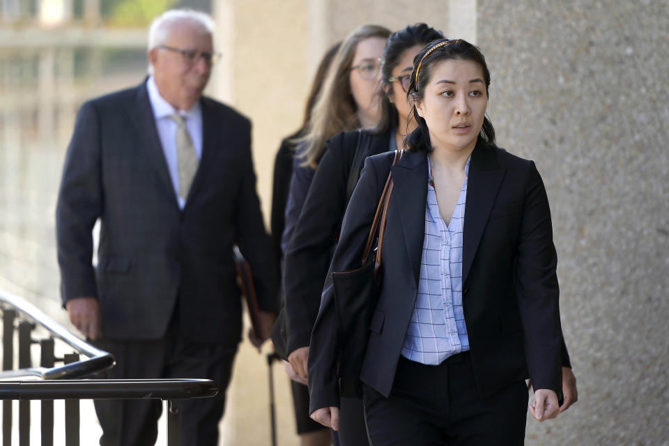 Tiffany Li, foreground, arrives at the courthouse Thursday, Sept. 12, 2019, in Redwood City, Calif. The trial of Li, a Chinese real estate scion who posted a $35 million bail after being charged with orchestrating the 2016 murder of her children's father, is set to start Thursday.(AP Photo/Tony Avelar)