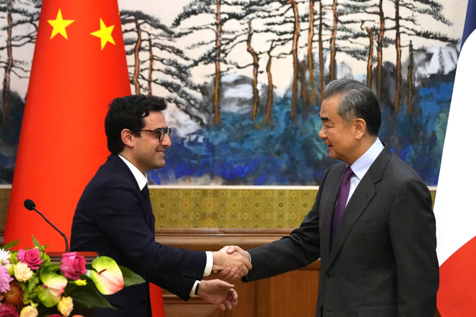 Chinese Foreign Minister Wang Yi, right, shakes hands with French Foreign Minister Stephane Sejourne, left, after a joint press conference at the Diaoyutai State Guesthouse in Beijing, China, Monday, April 1, 2024. (Ken Ishii/Pool Photo via AP)