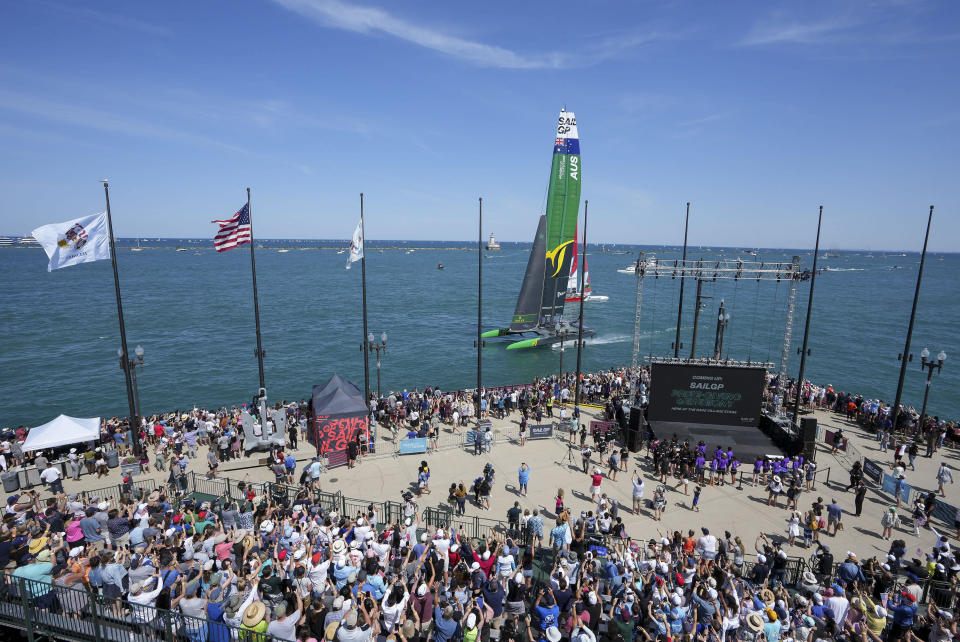 In this photo provided by SailGP, Australia's SailGP Team sail close to spectators on Navy Pier as they celebrate after winning the United States Sail Grand Prix sailing race in Lake Michigan in Chicago, Sunday, June 19, 2022. (Adam Warner/SailGP via AP)
