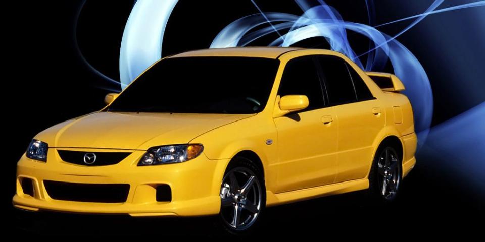 Land vehicle, Vehicle, Car, Yellow, Mazda familia, Mazda, Rim, Bumper, Automotive design, Full-size car, 