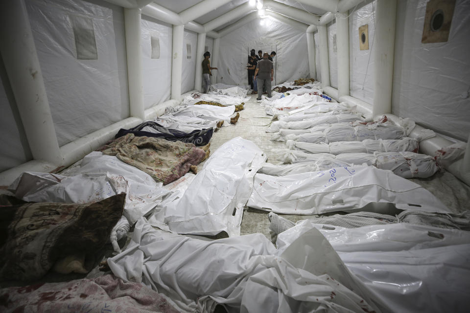 Bodies of Palestinians killed by an explosion at the Ahli Arab hospital are gathered at the front yard of the al-Shifa hospital, in Gaza City, central Gaza Strip, Tuesday, Oct. 17, 2023. The Hamas-run Health Ministry says an Israeli airstrike caused an explosion that killed hundreds at the Ahli Arab hospital, but the Israeli military says it was a misfired Palestinian rocket. (AP Photo/Abed Khaled)