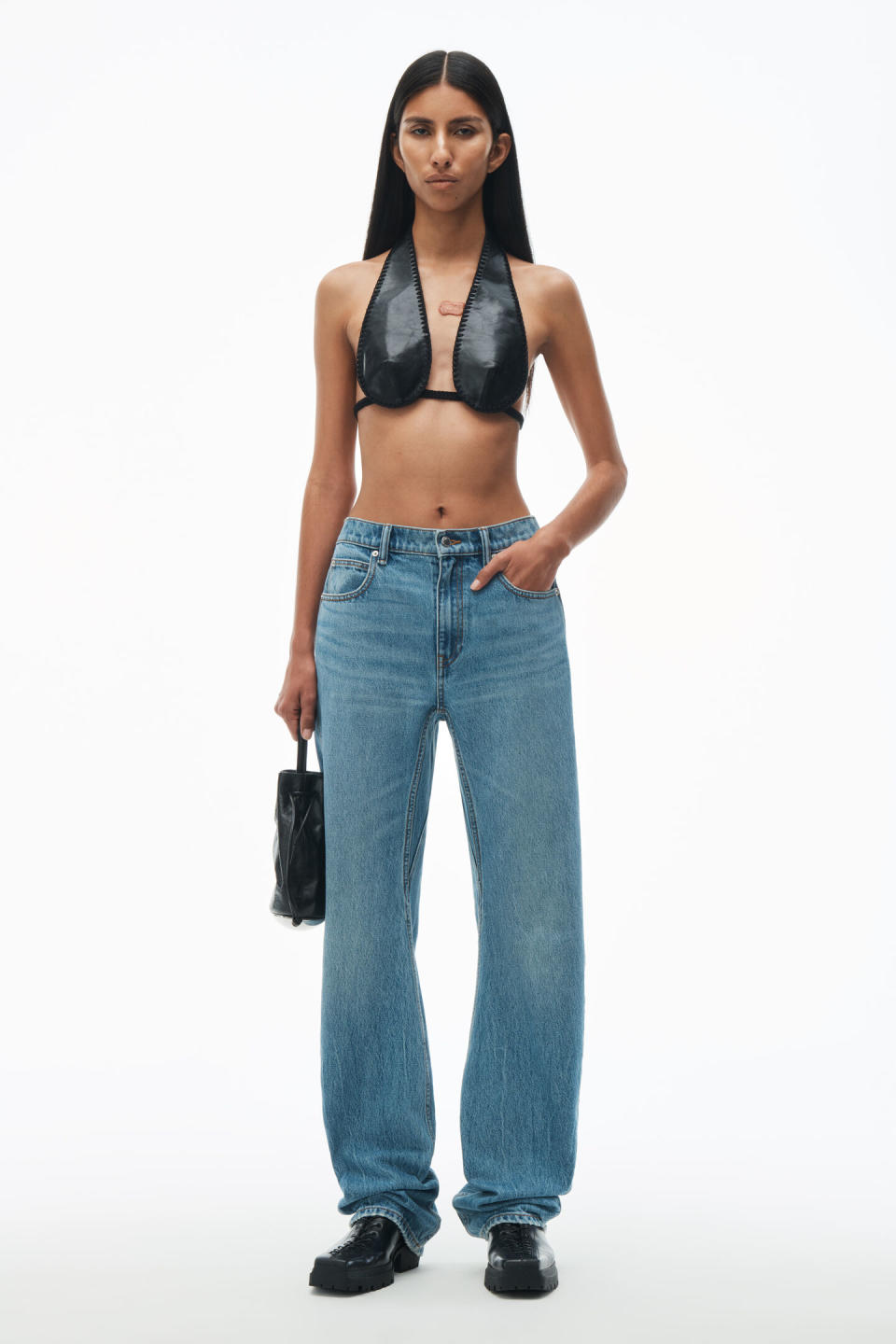 model wearing curve alexander wang denim jeans with black bralette