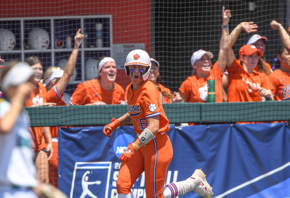 Clemson sophomore Alia Logoleo (16) reacts after she hits a home run off of UNC Wilmington freshman Emily Winstead (13) during the bottom of the first inning of the NCAA Clemson Softball Regional  at McWhorter Stadium in Clemson Friday, May 20, 2022.