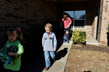 Stephanie Oakley follows her children as they leave for her son's chemotherapy treatment at their home in Oklahoma City, Oklahoma, U.S. November 26, 2018. Picture taken November 26, 2018. REUTERS/Nick Oxford
