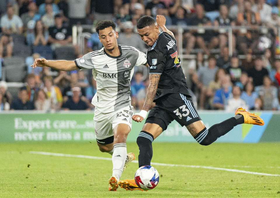 Minnesota United midfielder Kervin Arriaga (33) takes a shot and scores a goal in front of Toronto FC midfielder Brandon Servania (23) during the second half of an MLS soccer match Saturday, June 3, 2023, in St. Paul, Minn. (Alex Kormann/Star Tribune via AP)