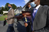 Attendees leave a public viewing for Herman Cain, Thursday, Aug. 6, 2020 in Atlanta. The former Republican presidential candidate, radio host, and entrepreneur died on July 30, after being hospitalized with COVID-19 and will be laid to rest this week. He was 74. (AP Photo/John Amis)