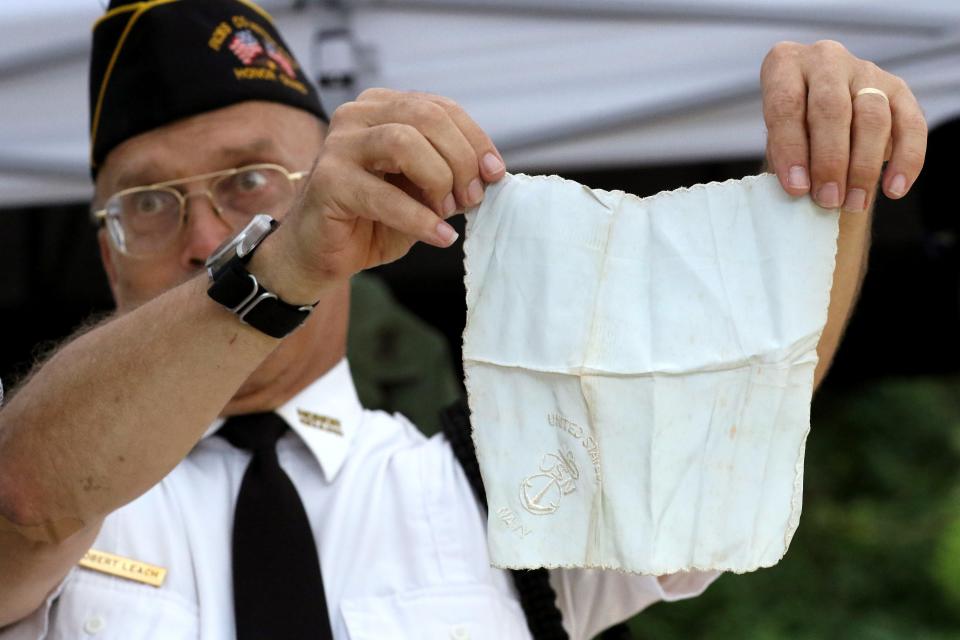 Robert Leach, of the Ross County Service Commission, holds up a Navy handkerchief that once belonged to Joseph T Hoffman as he talks about the history of Hoffman during a memorial service in the honor of Joseph T. Hoffman, who died on December 7, 1941 aboard the U.S.S Oklahoma in the attack on Pearl Harbor, at The Joseph W. Hoffman American Legion Post 757 in Chillicothe, Ohio on August 20, 2022.  The remains of Hoffman were found after 80 years and have been brought home. 