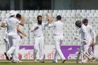 Cricket - Bangladesh v England - Second Test cricket match - Sher-e-Bangla Stadium, Dhaka, Bangladesh - 30/10/16. England's Moeen Ali (C) celebrates with his teammates after taking the wicket of Bangladesh's Imrul Kayes. REUTERS/Mohammad Ponir Hossain
