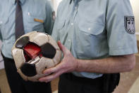 A German customs officer holds a confiscated soccer ball used as a hiding spot to smuggle cigarettes to Germany at the Finance ministry in Berlin March 11, 2011. Reuters/Fabrizio Bensch